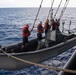U.S. Sailors get lowered in a RHIB