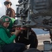 A Sailor preflight checks an MH-60S