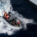 Sailors operate a rigid-hull inflatable boat