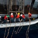 Sailors raise a rigid-hull inflatable boat