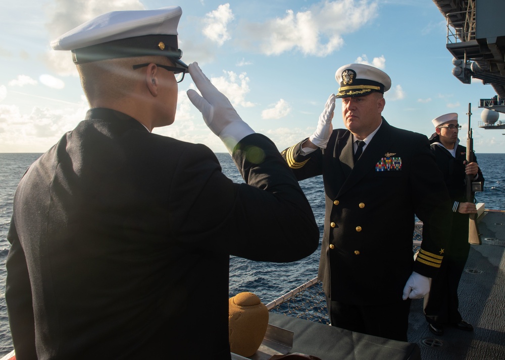 Sailors participate in a Burial at Sea