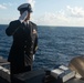 U.S. Navy Religious Programs Specialist Chief Timothy Cambiado renders honors during a burial at sea