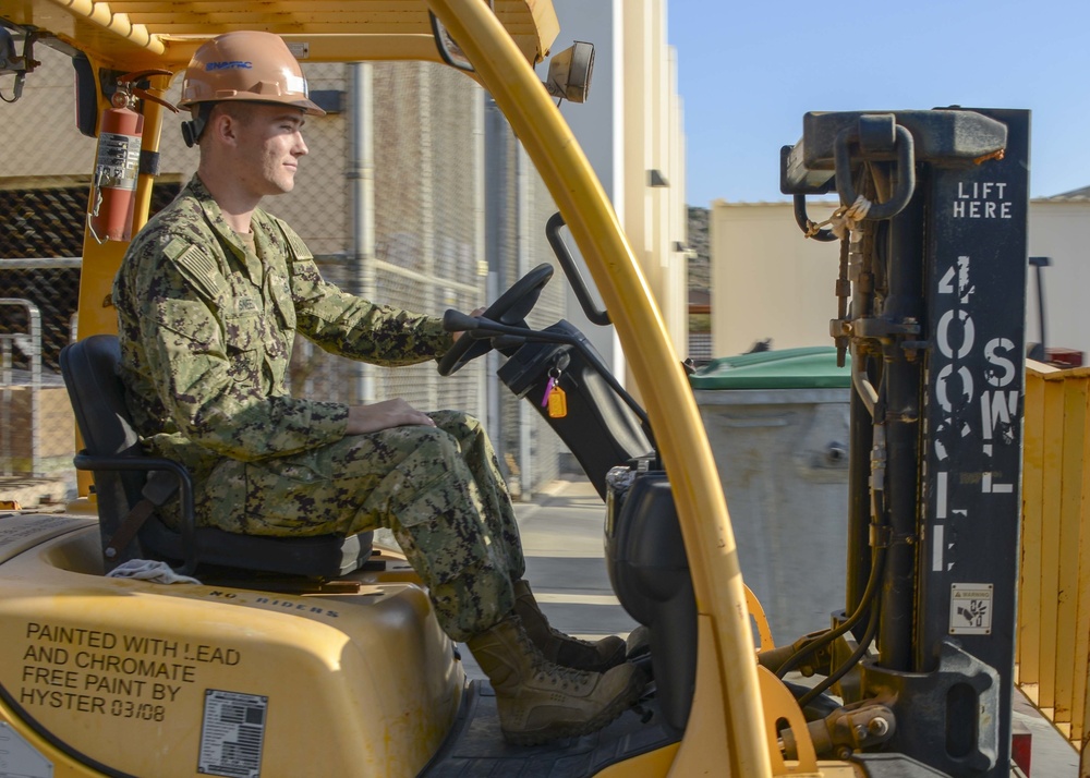 Seabee Operates Forklift