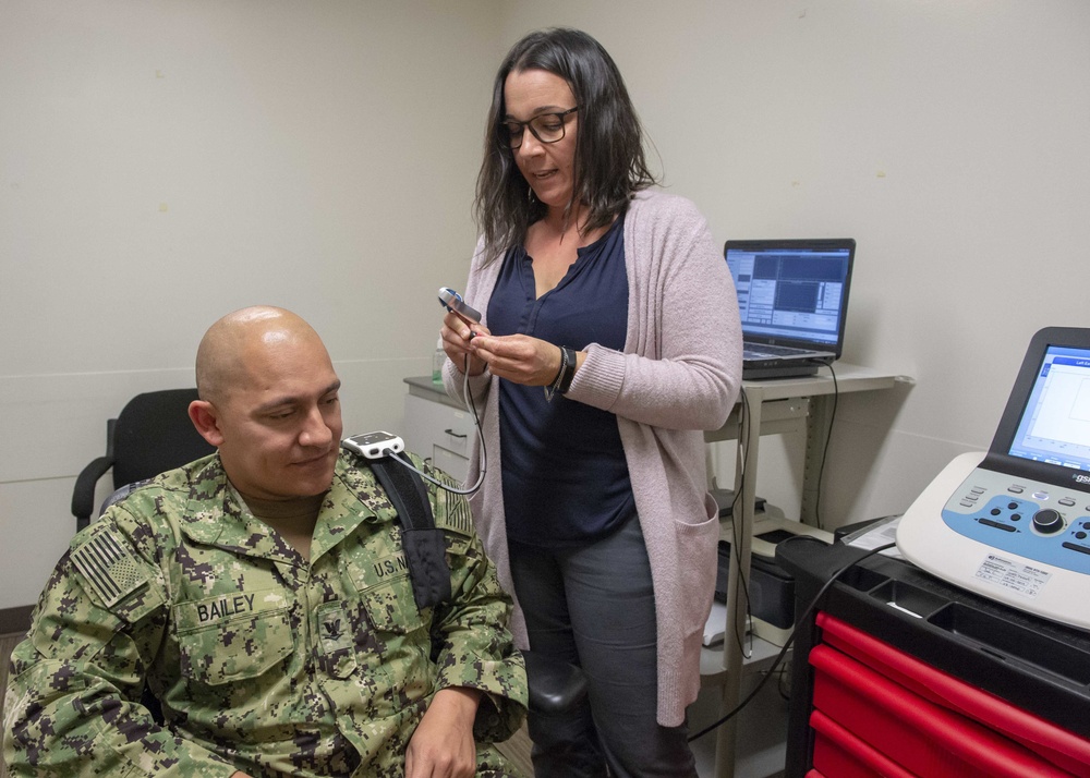 Audiologist Performs Test