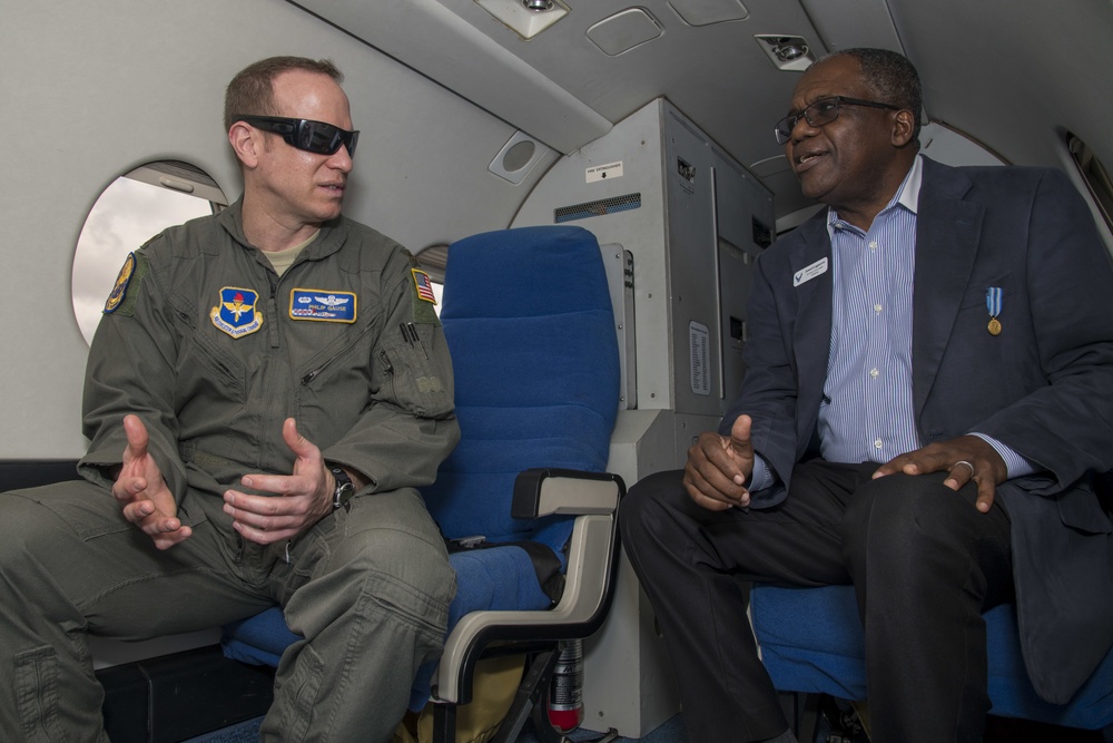 U.S. Air Force Maj. Philip Gause speaks with Jowel Laguerre, civic leader, onboard a T-1 Jayhawk aircraft Nov. 6, 2019