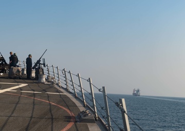 USS Farragut escorts Merchant Vessel Mohawk throught the Straits of Bab el-Mandeb