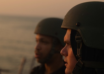 USS Farragut escorts Merchant Vessel Mohawk throught the Straits of Bab el-Mandeb