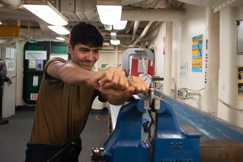 U.S. Sailor disassembles a gauge