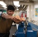 U.S. Sailor disassembles a gauge