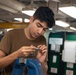 U.S. Sailor disassembles a gauge