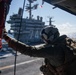 U.S. Navy Naval Air Crewman prepares to land on the flight deck of the aircraft carrier USS John C. Stennis