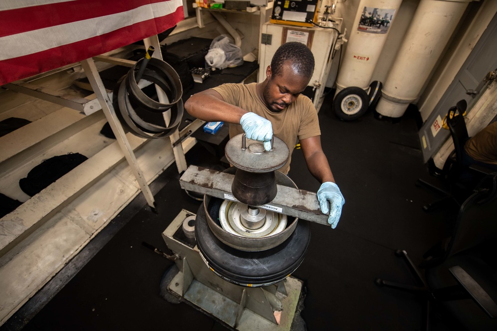 U.S. Sailor assembles an aircraft tire