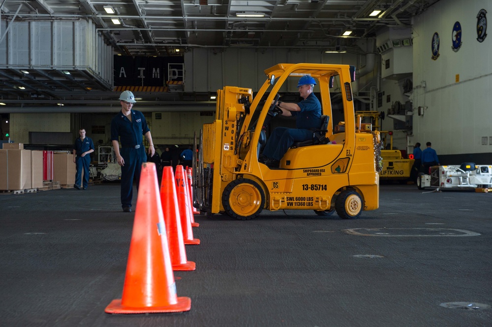 U.S. Navy Sailors drive forklift training course