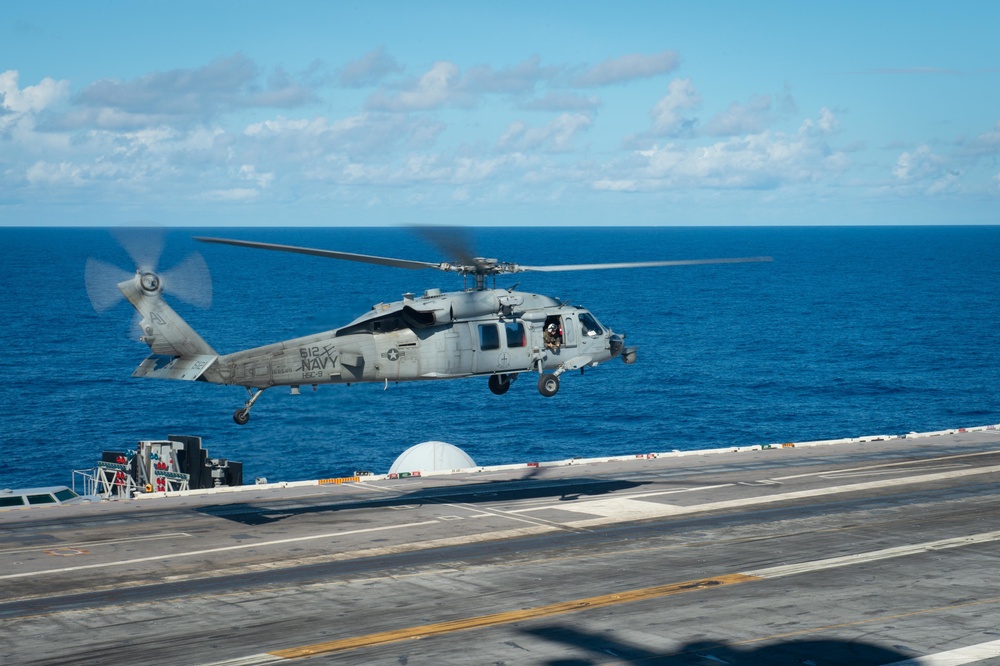 An MH-60S takes off from the flight deck