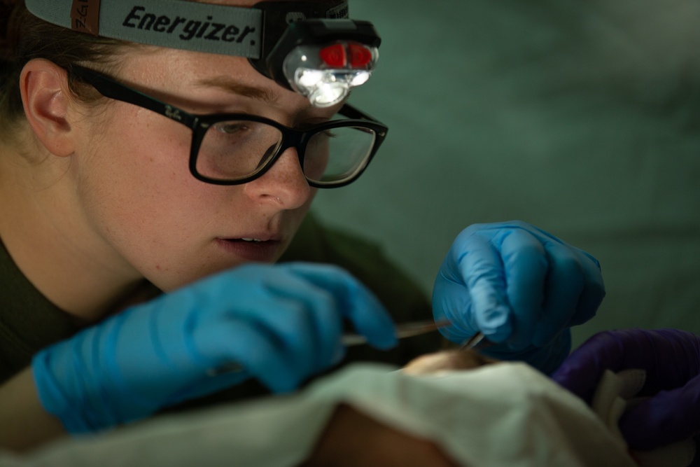 Corpsman performs suture on Marine