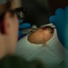Corpsman performs suture on Marine