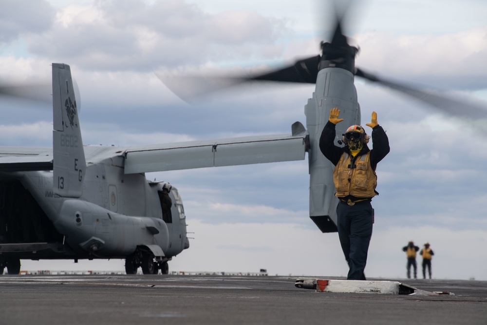 U.S. Sailor guides an MV-22 Osprey, assigned to Marine Medium Tiltrotor Squadron (VMM) 263