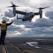 U.S. Sailor guides an MV-22 Osprey, assigned to Marine Medium Tiltrotor Squadron (VMM) 263, as it prepares to land on the flight deck of the aircraft carrier USS John C. Stennis (CVN 74)