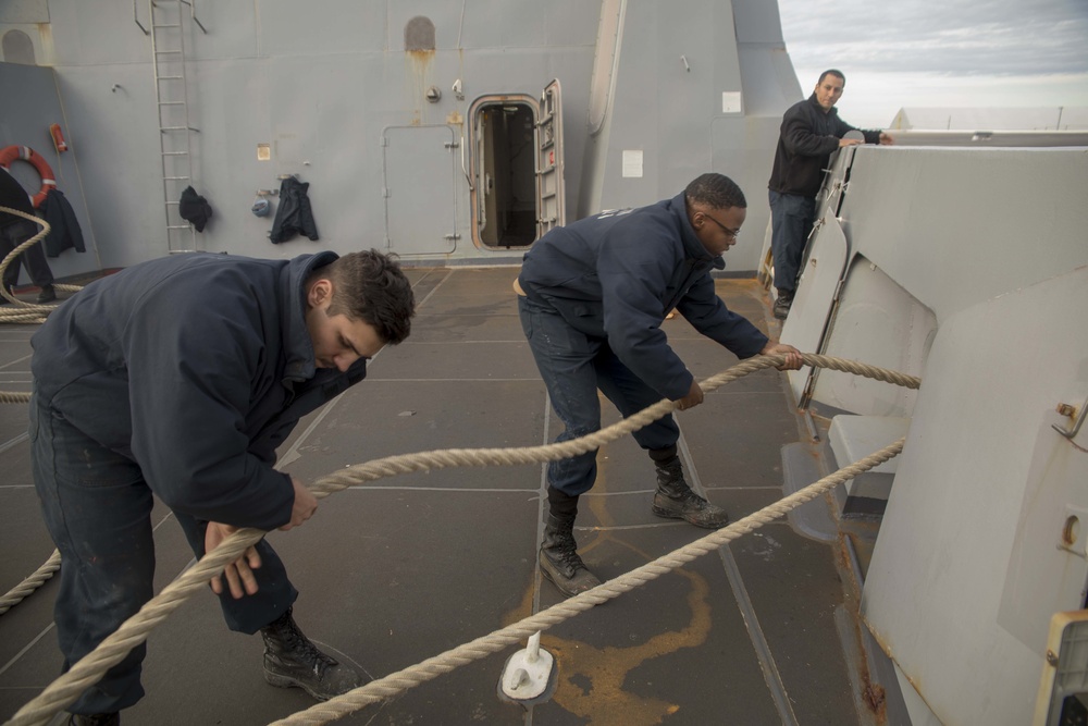 Sailors give slack on mooring line