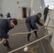 Sailors give slack on mooring line