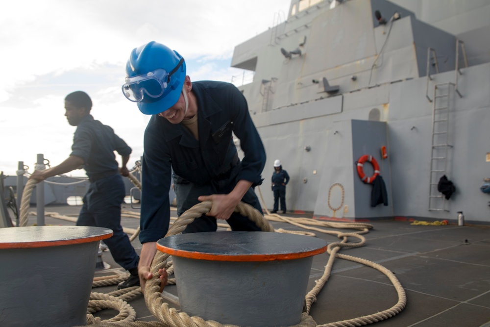 Sailor wraps mooring line around a bollard