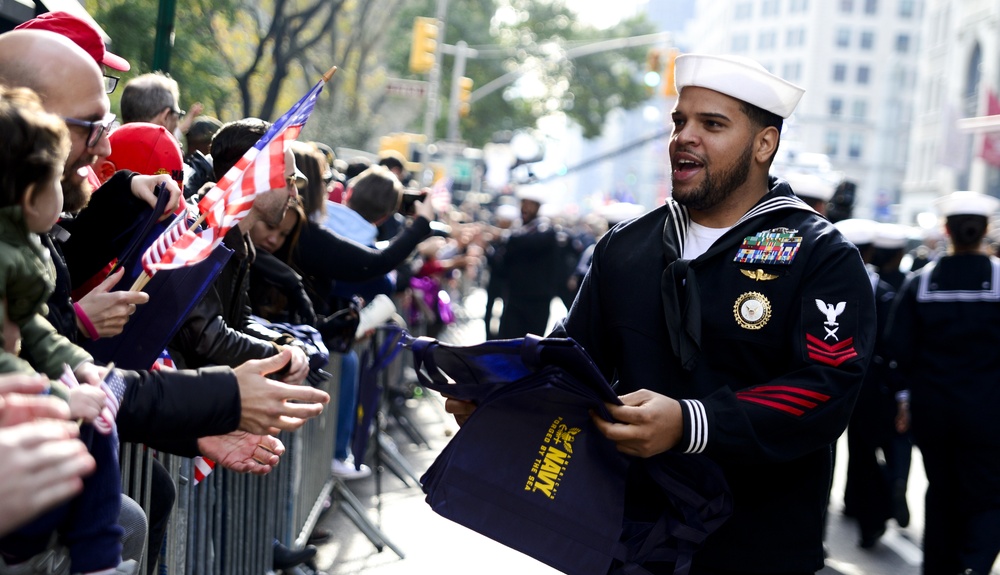 Sailors assigned to Navy Recruiting District New York pass out Navy-themed gifts