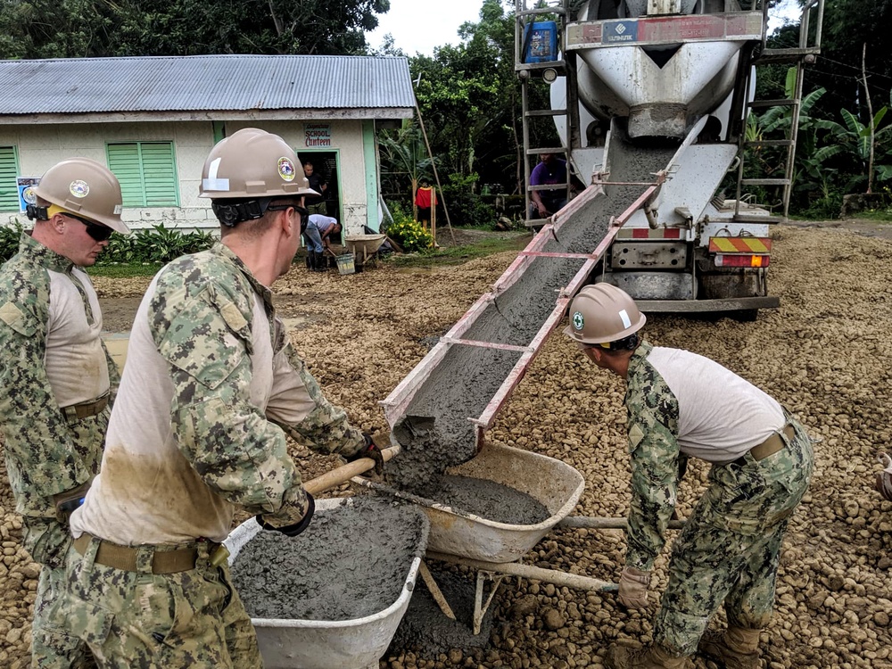 NMCB-5’s Detail Palawan and the Armed Forces of the Philippines 2nd NMCB work together to place concrete at Malatgao Elementary School