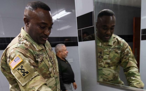 Command Sgt. Maj Maynard inspects faucet in Puerto Nuevo, Puerto Rico