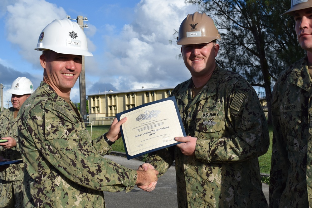 U.S. Navy Seabee deployed with NMCB-5’s Detail Guam receives the Seabee Combat Warfare Qualification