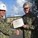 U.S. Navy Seabee deployed with NMCB-5’s Detail Guam receives the Seabee Combat Warfare Qualification