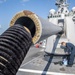 A Sailor Aboard USS Milius (DDG 69) Cleans the Mark 45 5 Inch Gun