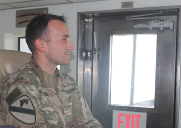 Warrant Officer Brandon Tune scans the waters off of Kuwait Naval Base