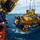 A large yellow remotely operated vehicle (ROV) or submarine rescue vehicle is being deployed or recovered from a ship over open ocean waters. Several crew members in dark clothing and caps are observing the operation from the ship's orange-railed deck. A large cable reel/winch system is visible in the upper left, suggesting the vehicle is being lowered or raised via tether.