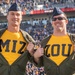 Pilots from Whiteman Air Force Base reveal their Mizzou shirts during the University of Missouri military appreciation game