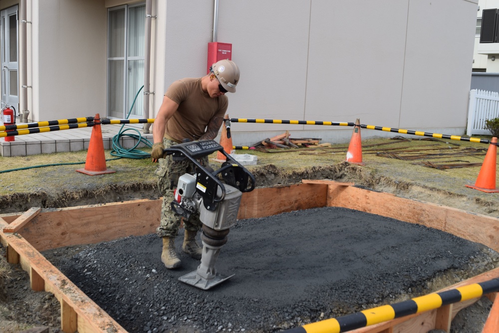 U.S. Navy Seabees deployed with Naval Mobile Construction Battalion 5’s Detail Iwakuni prepare for concrete placement