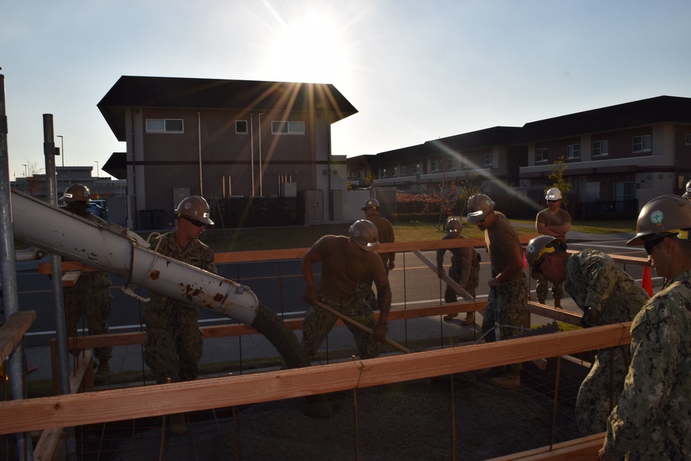 U.S. Navy Seabees deployed with Naval Mobile Construction Battalion 5’s Detail Iwakuni prepare for concrete placement