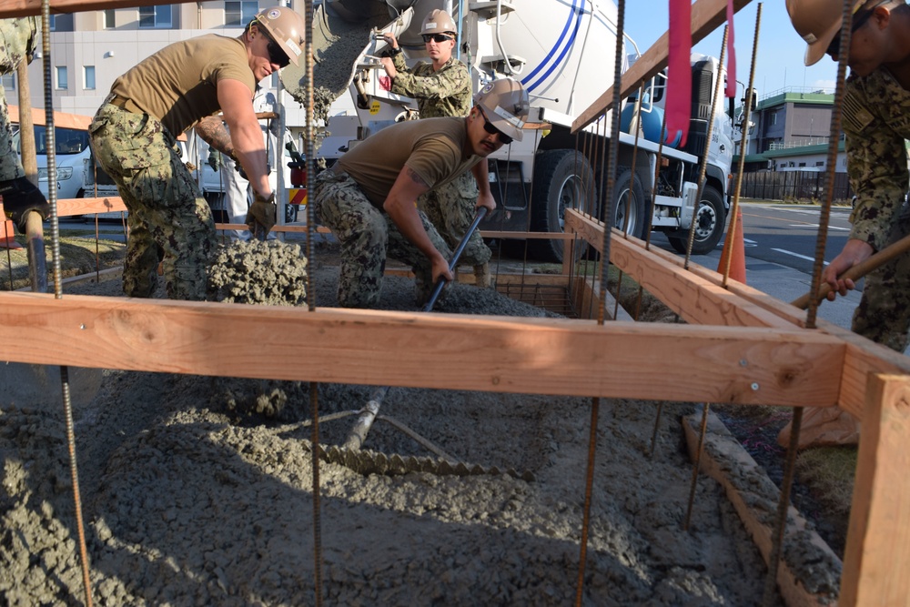 U.S. Navy Seabees deployed with Naval Mobile Construction Battalion 5’s Detail Iwakuni prepare for concrete placement