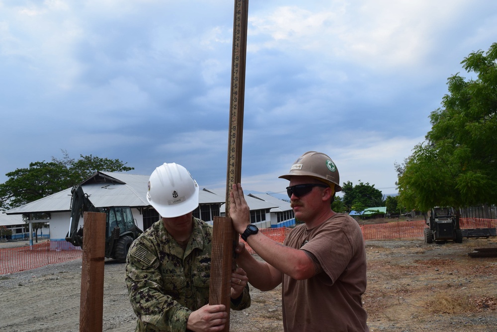 U.S. Navy Seabees deployed with Naval Mobile Construction Battalion 5's Detail Timor-Leste prepare for construction on an education center