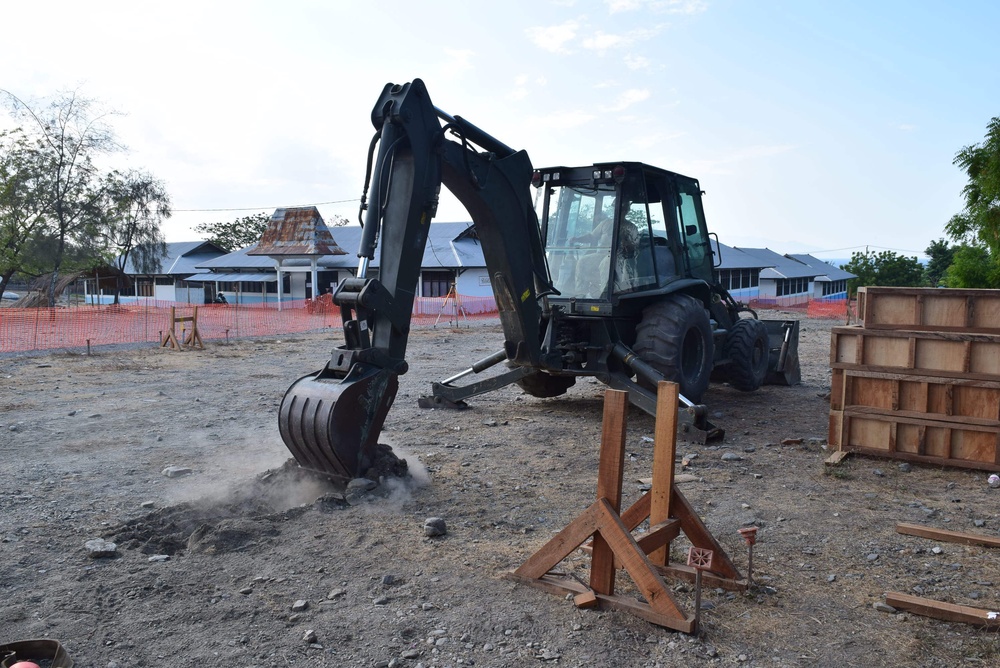 U.S. Navy Seabees deployed with Naval Mobile Construction Battalion 5's Detail Timor-Leste prepare for construction on an education center