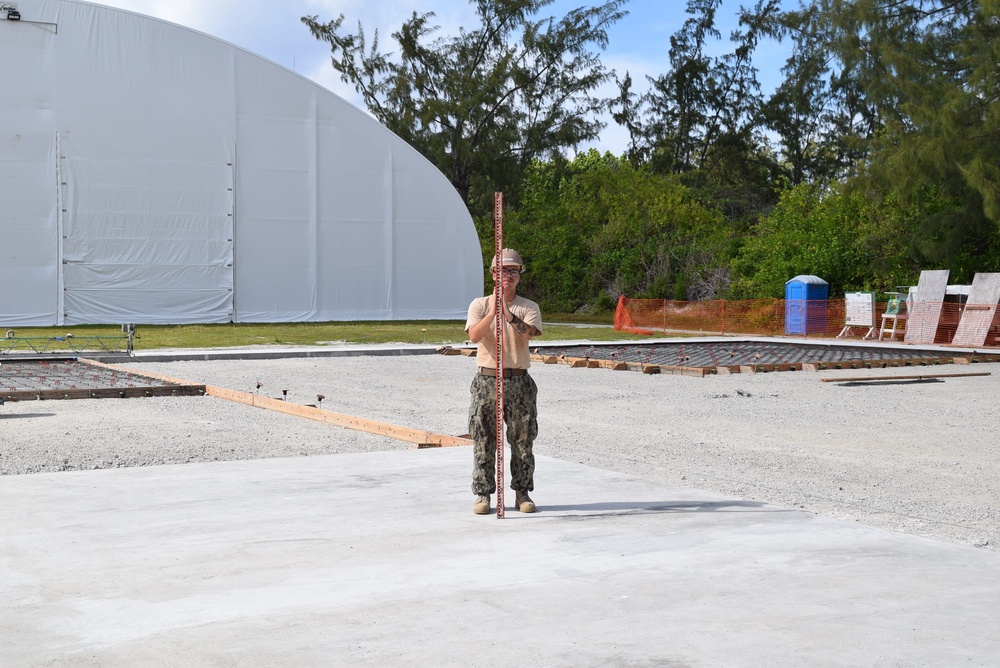 U.S. Navy Seabees deployed to Naval Mobile Construction Battalion 5’s Detail Diego Garcia check elevation on a new a concrete pad