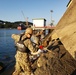 U.S. Navy Seabees deployed with Naval Mobile Construction Battalion 5’s Detail Sasebo place concrete for the seawall port repairs on Commander Fleet Activities Sasebo