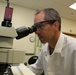 BioTesting Division microbiologist Jeremy Beard examines samples taken from the protective suits under a fluorescing microscope.