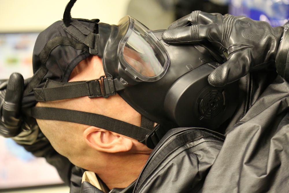 Sgt. 1st Class William Anderson of the 690th CBRN Company, Alabama National Guard, dons an M50 mask in preparation for the TPP test.