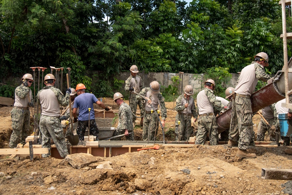 U.S. Navy Seabees deployed with NMCB-5’s Detail Palawan and Seabees from the Armed Forces of the Philippines 2nd NMCB place concrete