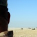 Task Force Spartan soldier watches Qatar armoured vanguard vehicles