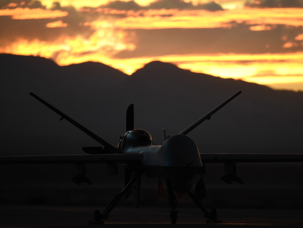 MQ-9 Reaper and aircrew underneath Nevada sunset