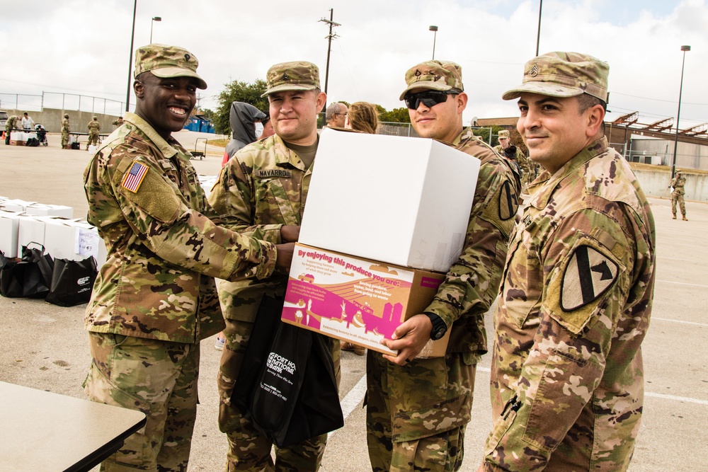 The team of religious affairs specialists from 1st Armored Brigade Combat Team, 1st Cavalry Division smile for a picture in the midst of assisting with distributing Thanksgiving food baskets on Nov. 20 at the Main Post Chapel on Fort Hood.
