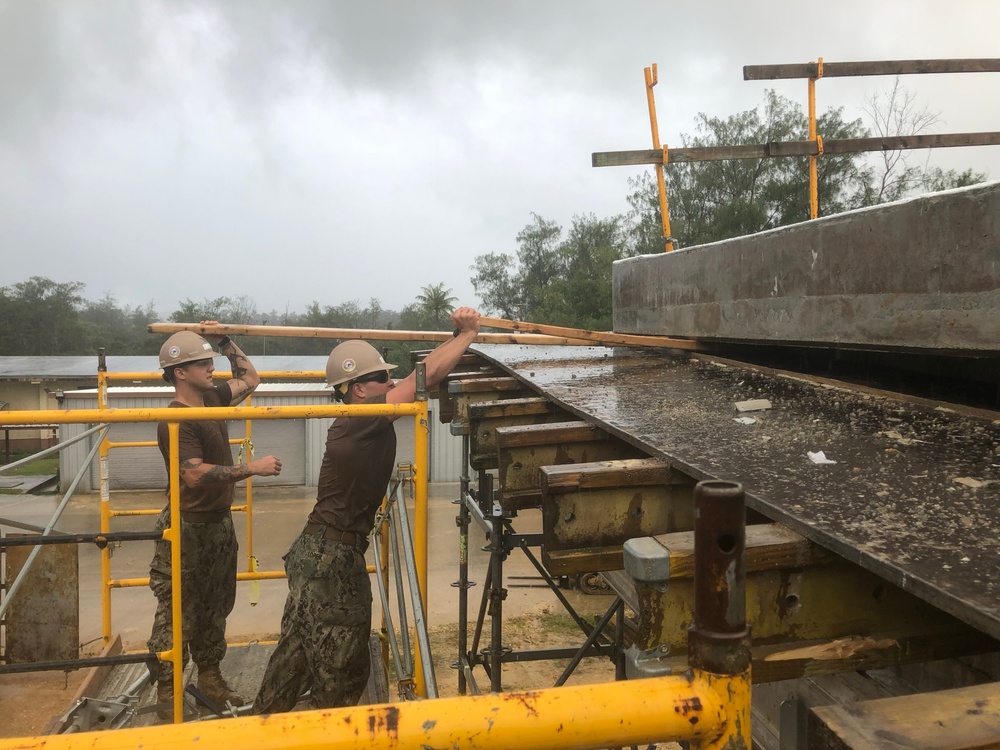 U.S. Navy Seabees deployed with NMCB-5’s Detail Tinian continue work on Explosive Ordnance Disposal Mobile Unit 5’s Boat Storage Facility