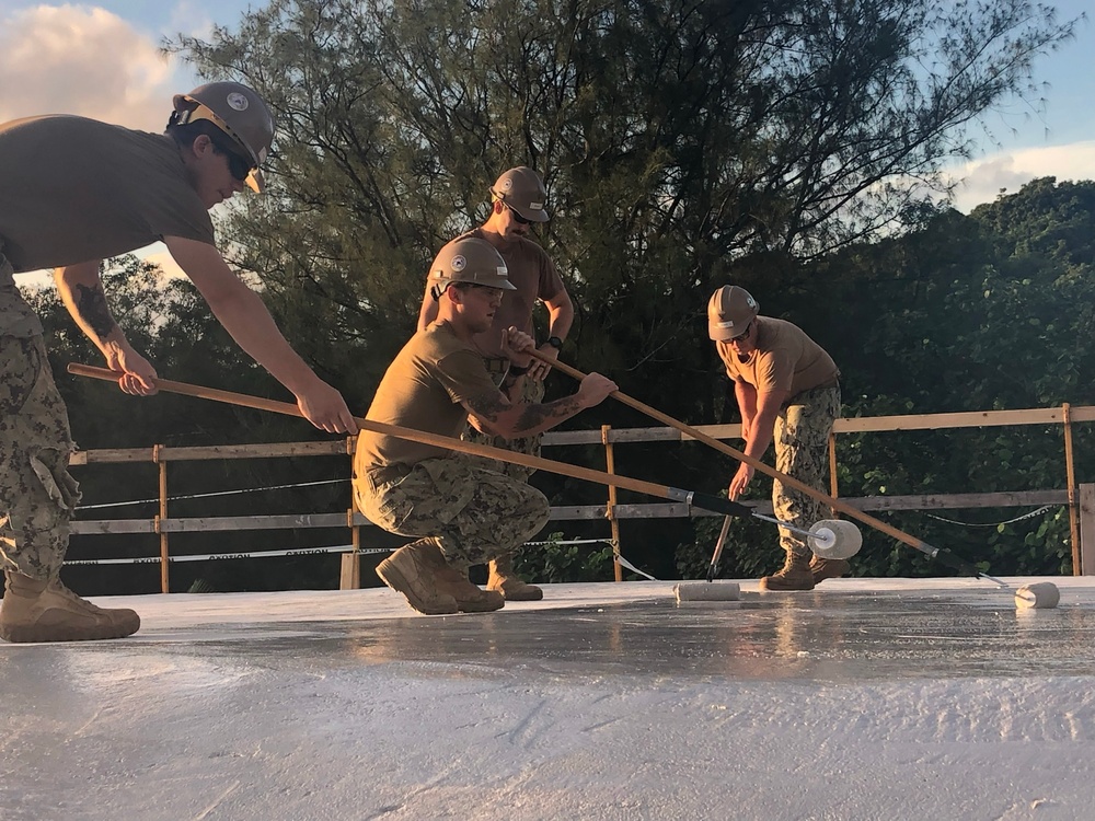 U.S. Navy Seabees deployed with NMCB-5’s Detail Tinian continue work on Explosive Ordnance Disposal Mobile Unit 5’s Boat Storage Facility