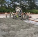 U.S. Navy Seabees from NMCB 5’s Detail Diego Garcia place concrete in support of the U.S. Air Force